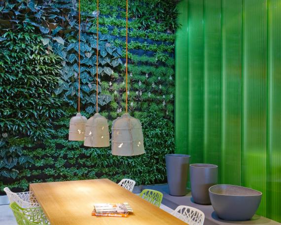 Showroom Creaplant detail pendant lights and planters in fibre cement from Eternit in front of vertical garden 