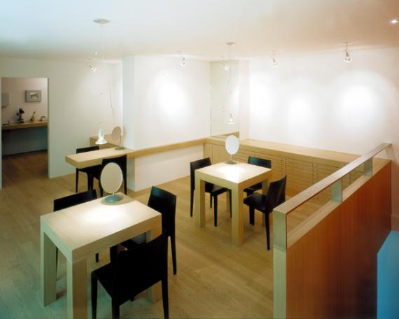 Viegener Optik optician store showroom with the consulting tables in oak 