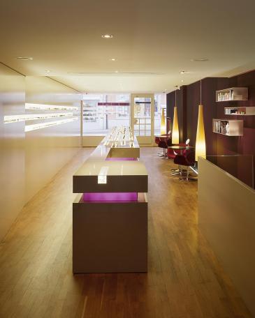 Urech Optik optician store with counter and movable display furniture in the middle of the room 