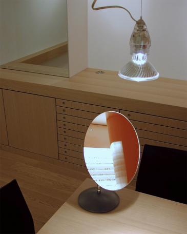 Viegener Optik optician store detail mirror on consulting tables in front of storage cabinets for glasses 