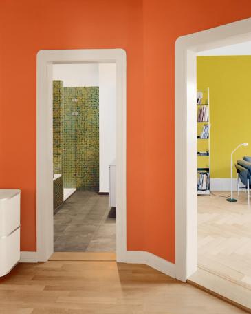 Wohnung Zürich orangefarbener Gang mit Blick ins Bad und Wohnzimmer