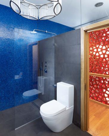Bathrooms London blue glass mosaics with shower and view to the staircase installation